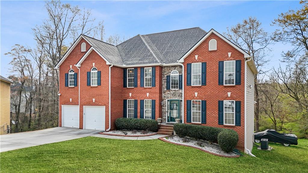 4320 Clarion Drive Conley, GA 30288 - Photo 4 of 49 a front view of a house with a yard and garage