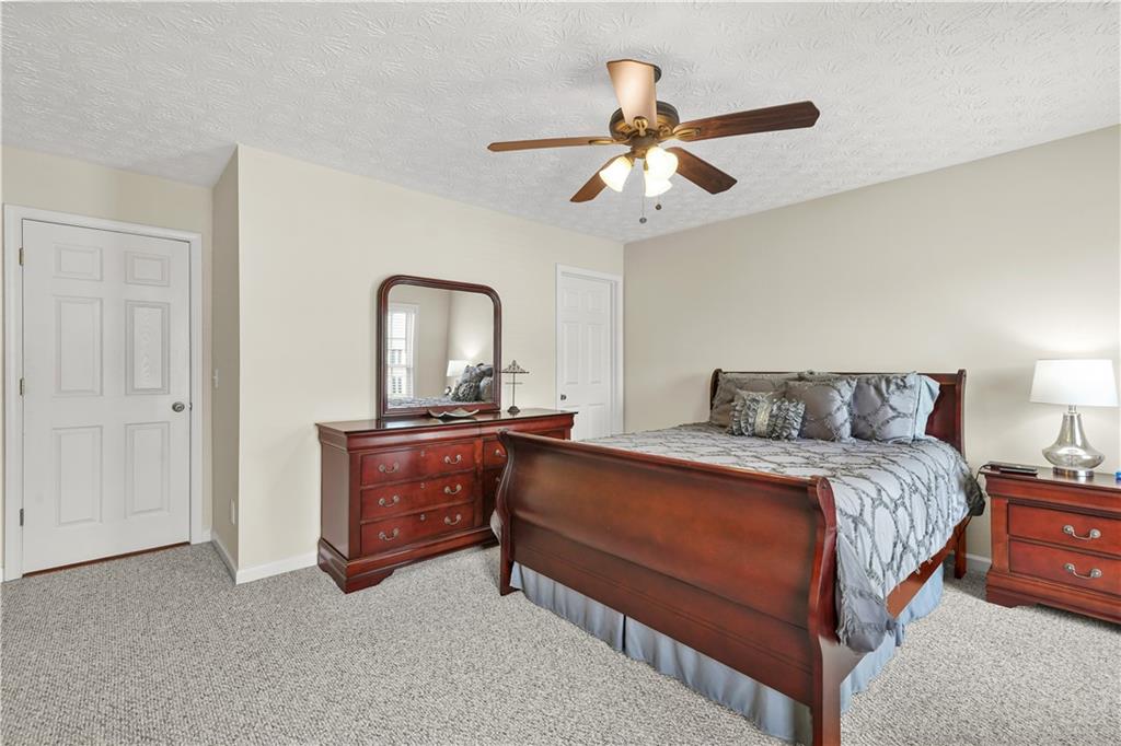 4320 Clarion Drive Conley, GA 30288 - Photo 41 of 49 a bedroom with a bed and a chandelier