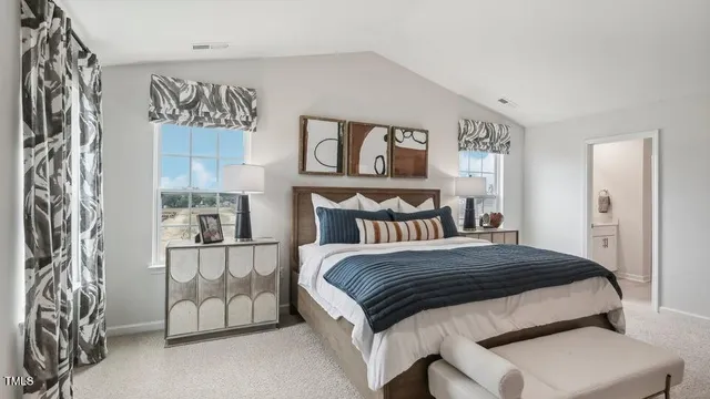 a bedroom with a bed and a night stand