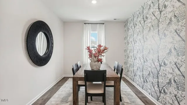 a dining room with furniture and a mirror