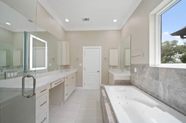 a large spacious bathroom with a granite countertop tub sink and mirror