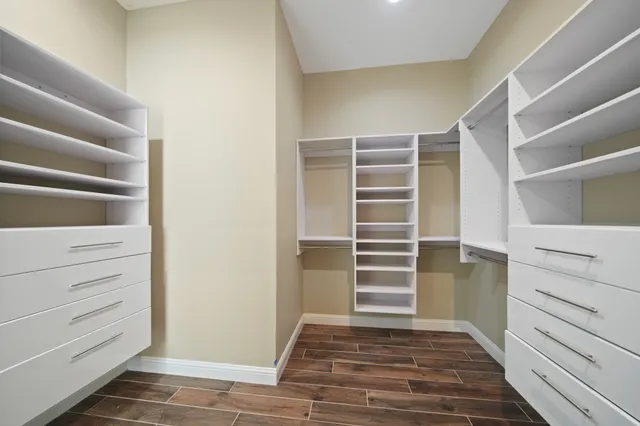 a view of walk in closet with empty racks
