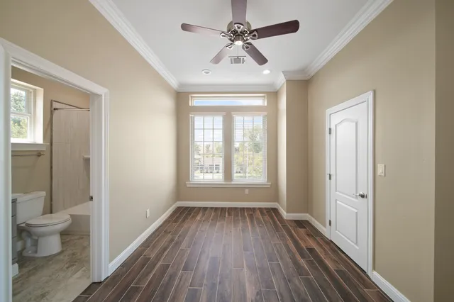 a view of a room with wooden floor and a window