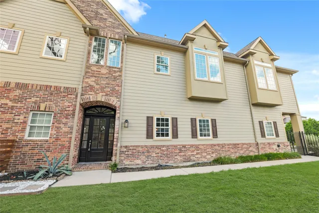 front view of brick house with a yard