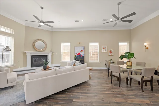 a living room with furniture a chandelier and a fireplace