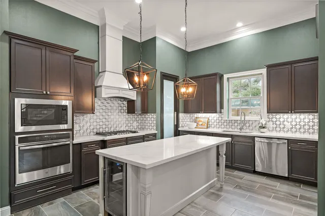 a kitchen with stainless steel appliances a sink stove and refrigerator