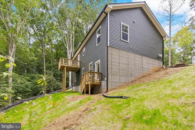 a view of a swimming pool with a patio and a yard