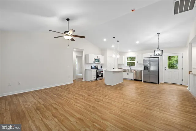 a kitchen with white cabinets sink and stainless steel appliances