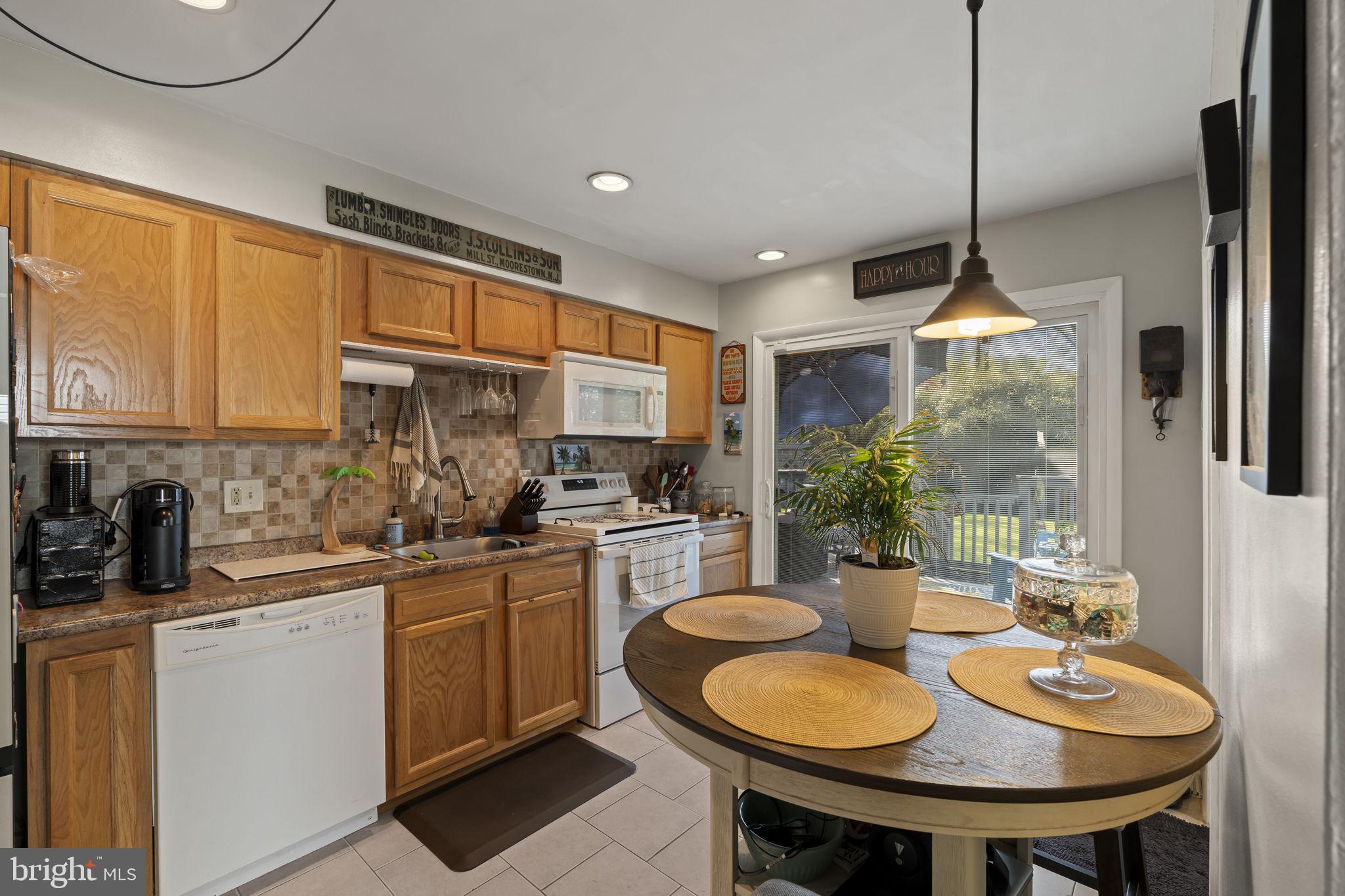 436 Carver Avenue Lawnside, NJ 08045 - Photo 12 of 32 a kitchen with sink a table and chairs