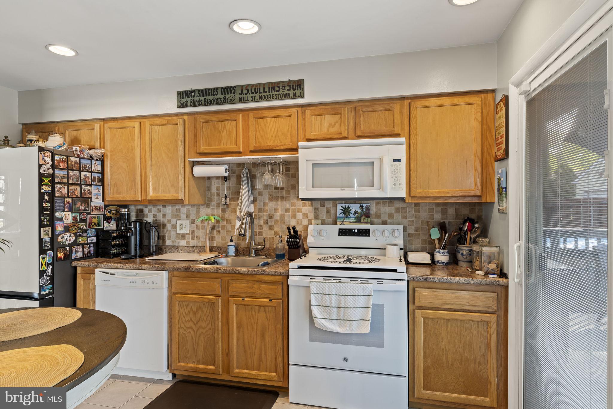 436 Carver Avenue Lawnside, NJ 08045 - Photo 13 of 32 a kitchen with a sink stove and cabinets