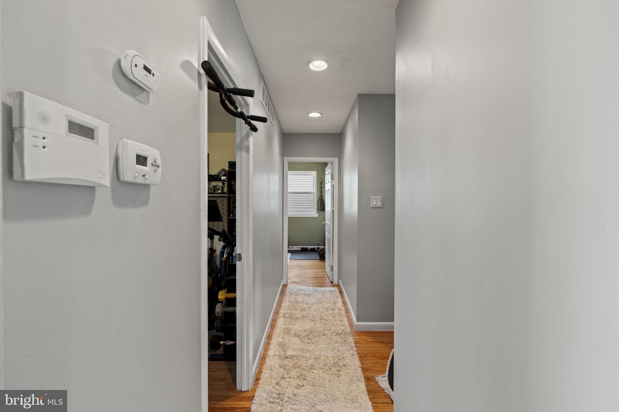 436 Carver Avenue Lawnside, NJ 08045 - Photo 21 of 32 a view of a hallway with wooden floor and a bathroom