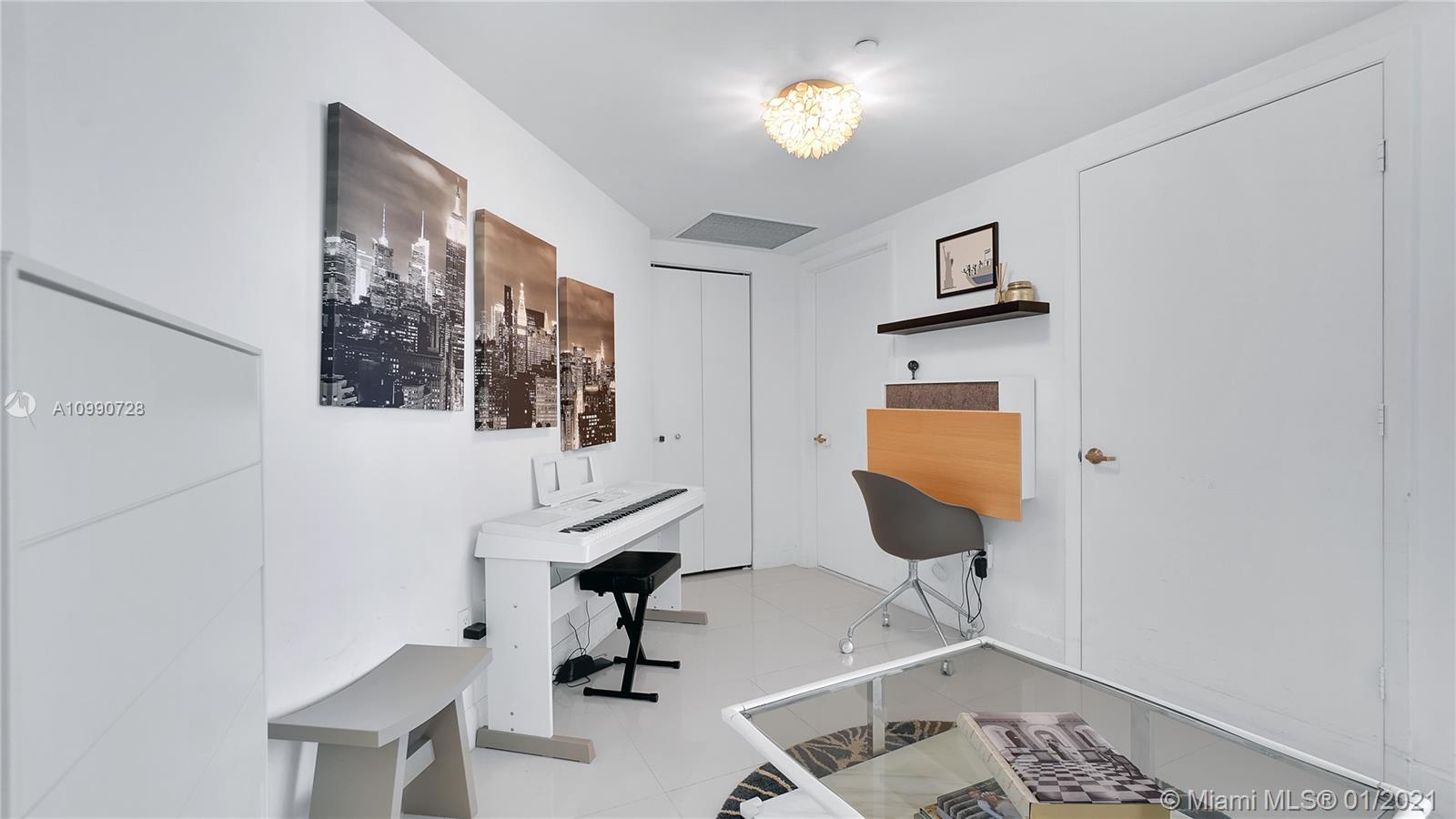 475 Brickell Avenue, Unit 5109 Miami, FL 33131 - Photo 12 of 31 a view of a workspace with furniture and mirror