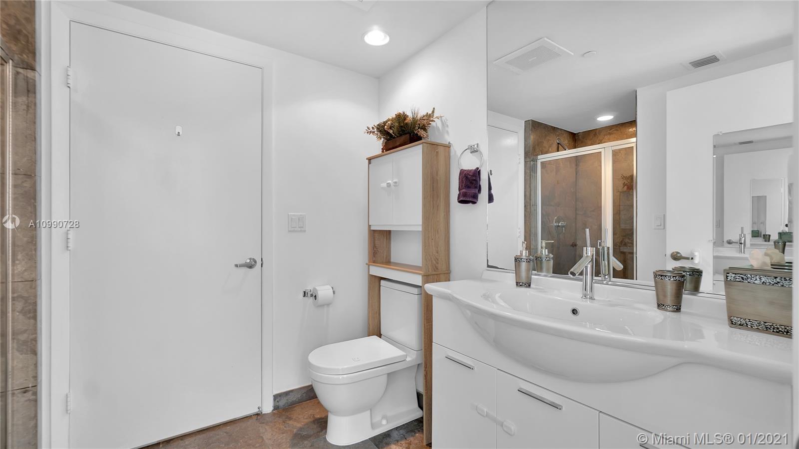 475 Brickell Avenue, Unit 5109 Miami, FL 33131 - Photo 14 of 31 a bathroom with a sink toilet and shower