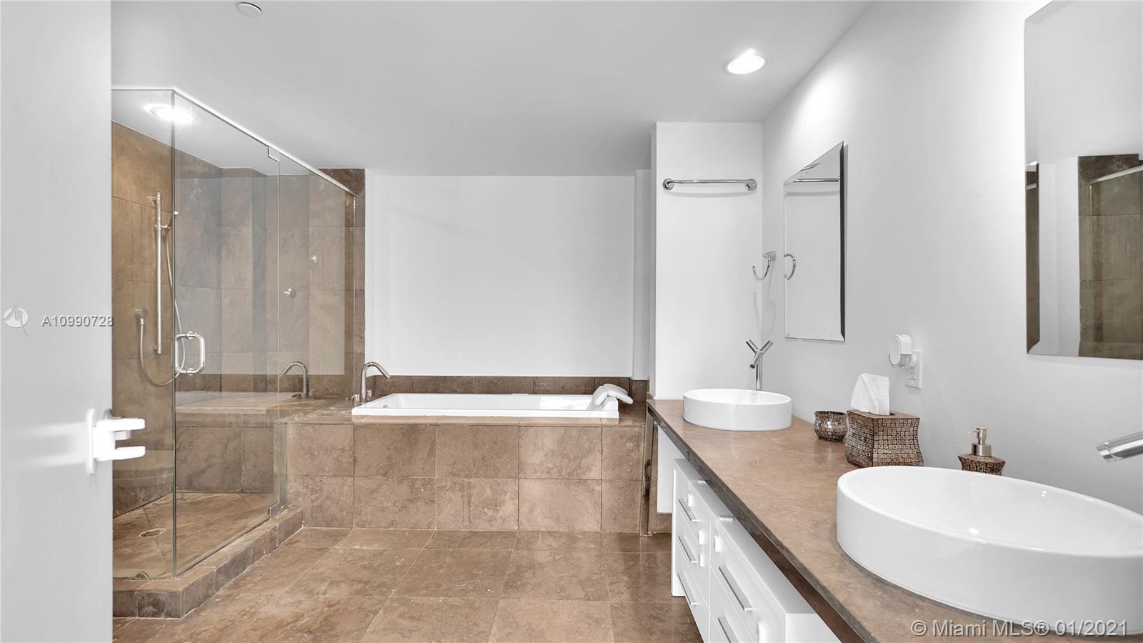 475 Brickell Avenue, Unit 5109 Miami, FL 33131 - Photo 18 of 31 a bathroom with double vanity sinks double vanity shower and a bathtub