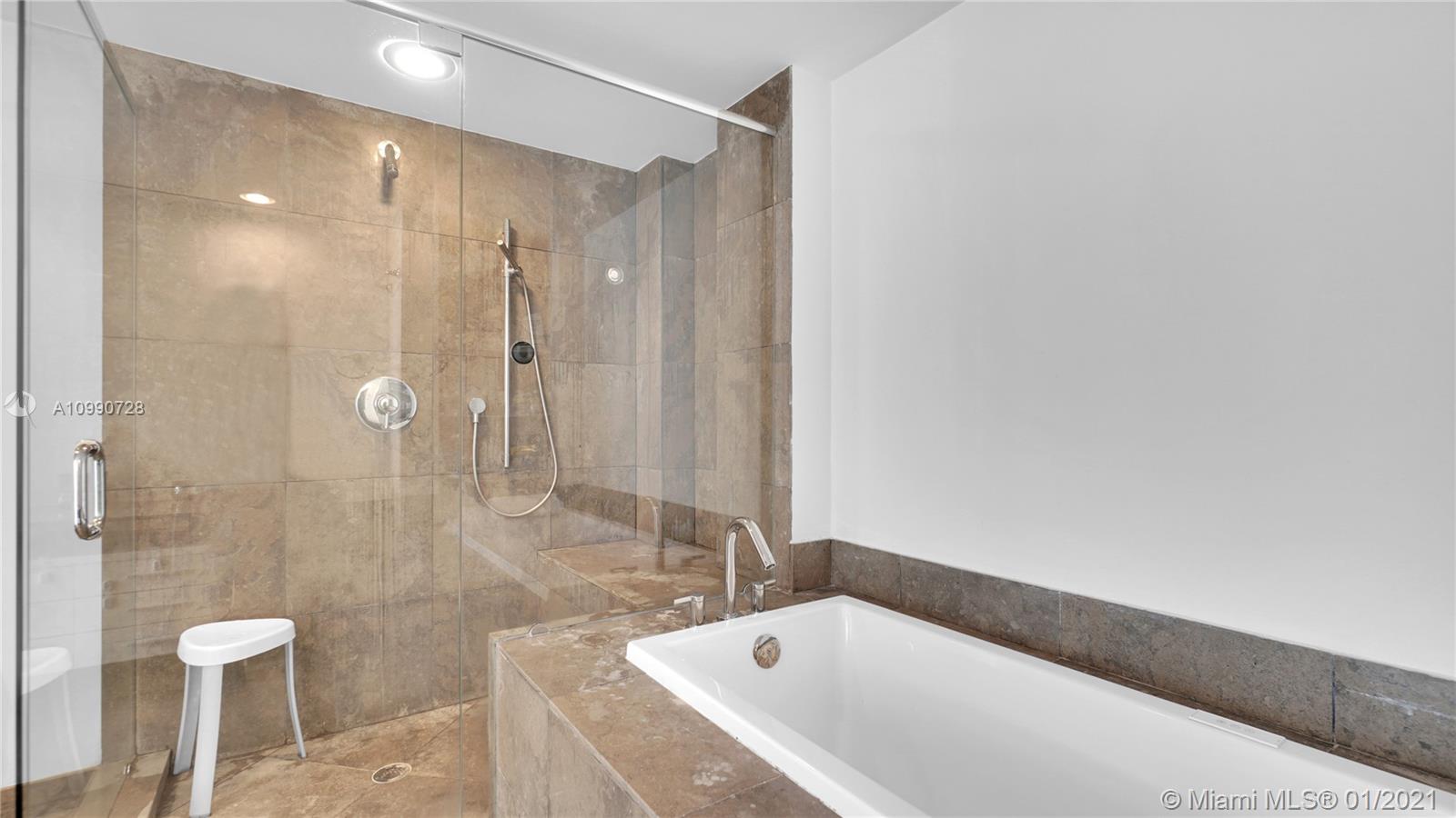 475 Brickell Avenue, Unit 5109 Miami, FL 33131 - Photo 21 of 31 a bathroom with a bathtub and a shower