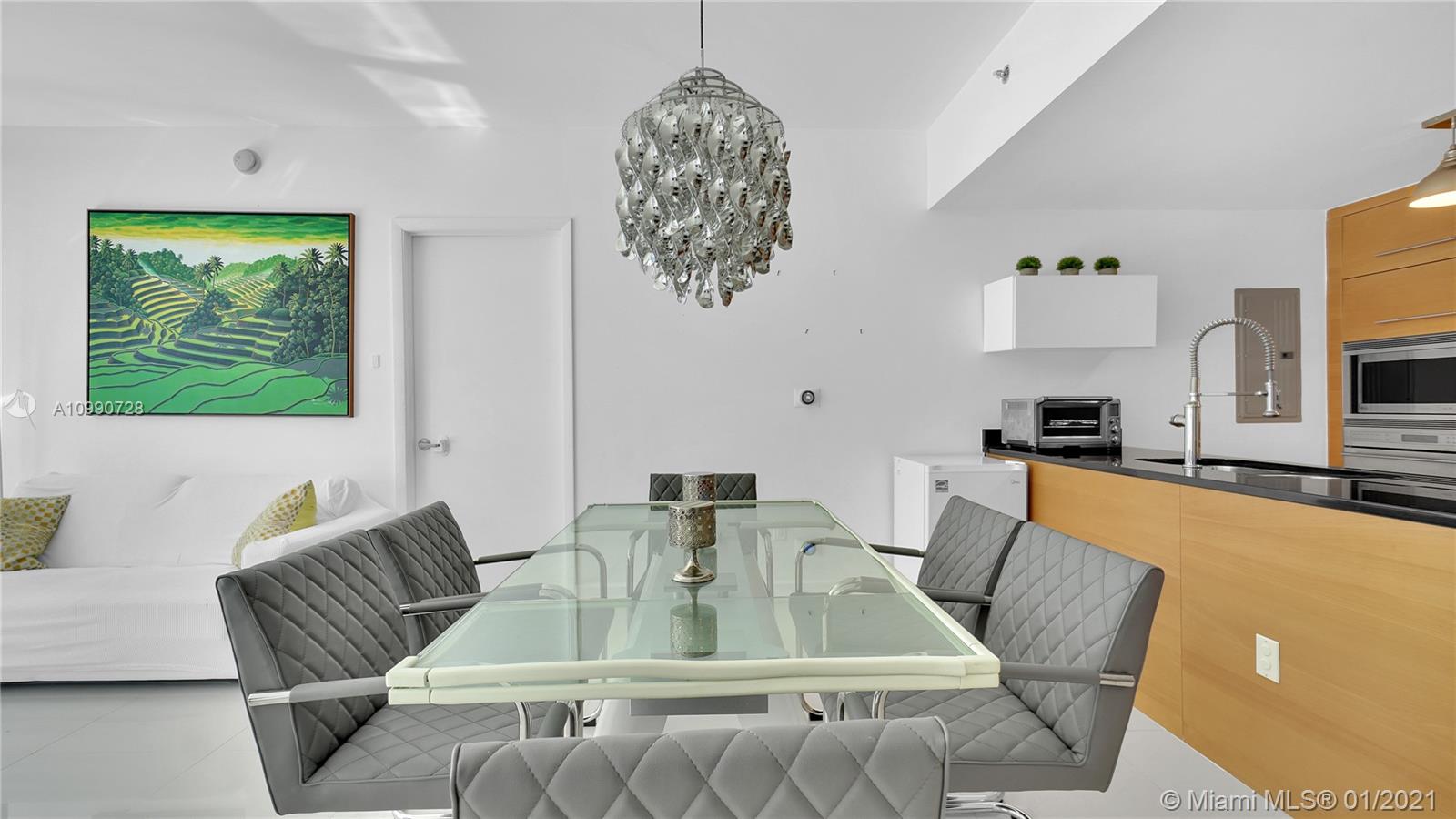 475 Brickell Avenue, Unit 5109 Miami, FL 33131 - Photo 7 of 31 a view of kitchen with stainless steel appliances table chairs and window