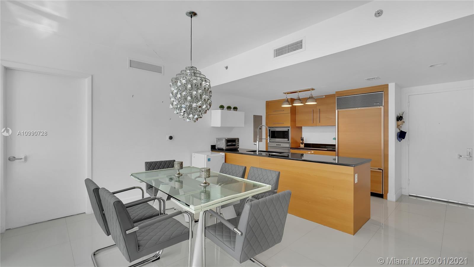 475 Brickell Avenue, Unit 5109 Miami, FL 33131 - Photo 8 of 31 a view of a dining room with furniture and chandelier