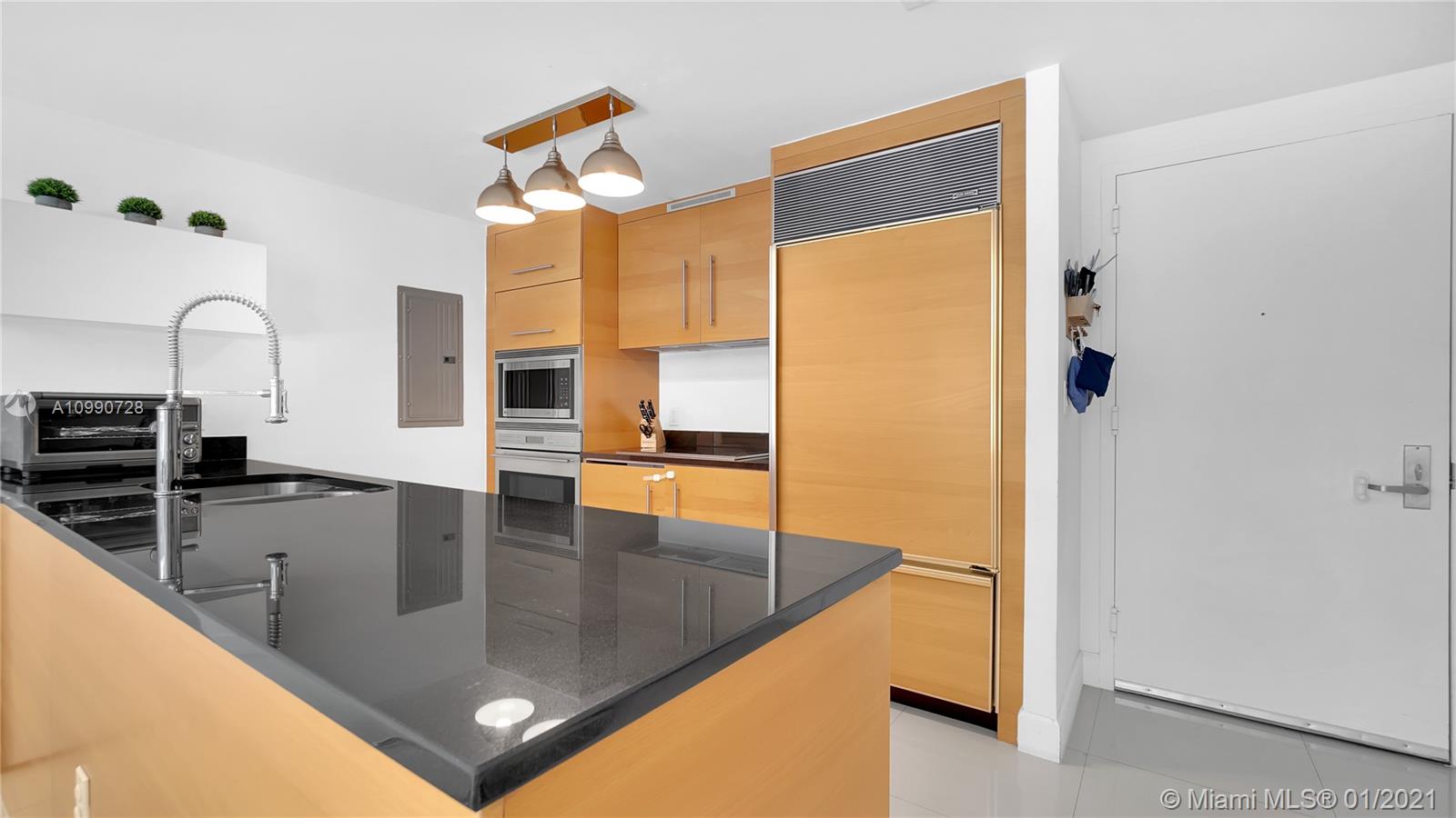 475 Brickell Avenue, Unit 5109 Miami, FL 33131 - Photo 9 of 31 a view of a kitchen with kitchen island a counter top space and stainless steel appliances