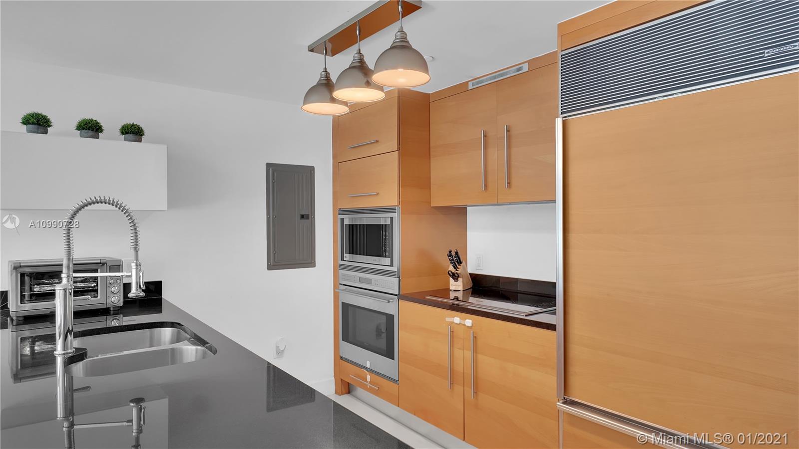 475 Brickell Avenue, Unit 5109 Miami, FL 33131 - Photo 10 of 31 a kitchen with granite countertop a refrigerator and a stove top oven