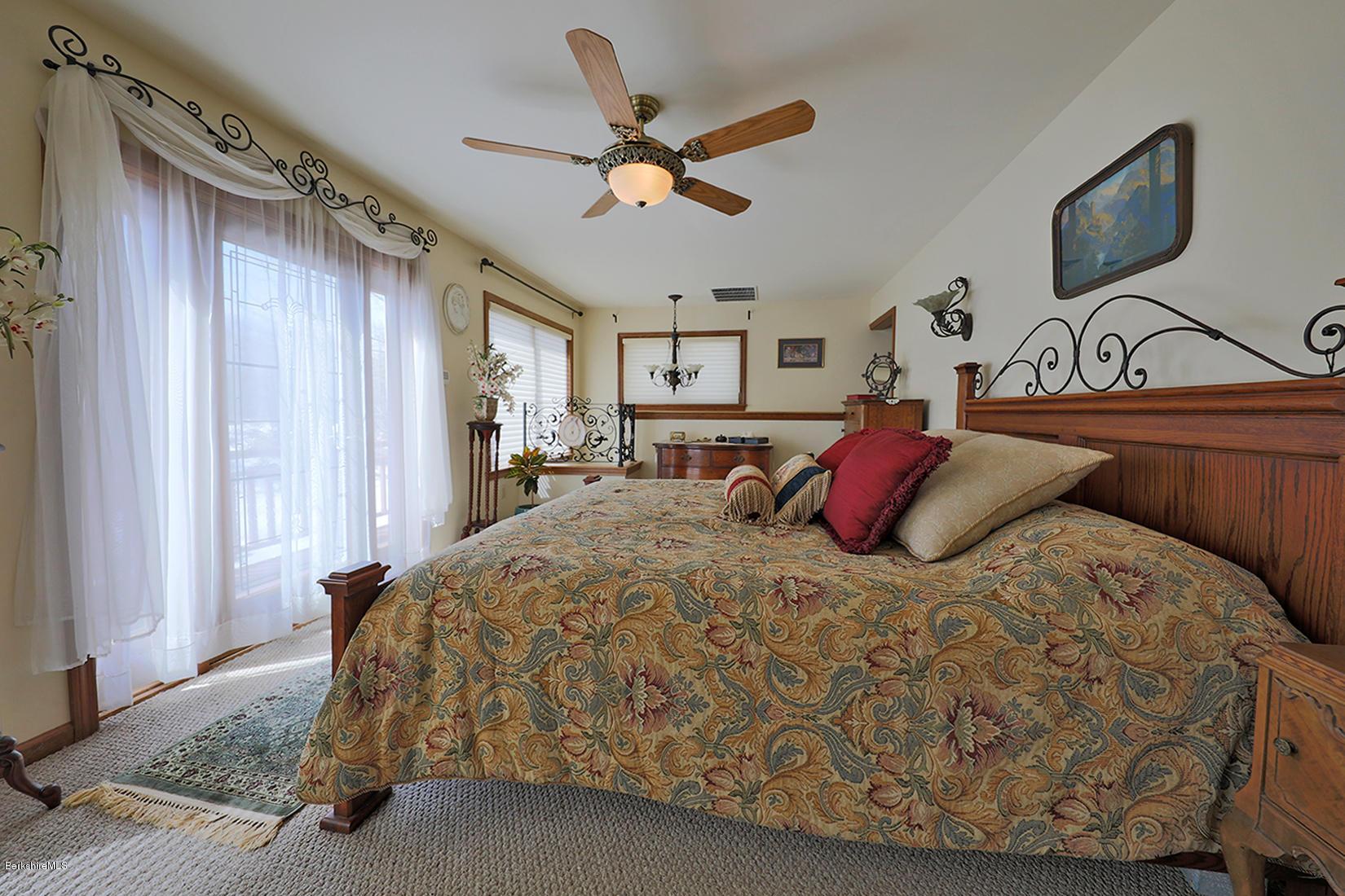 142 Kibbe Road Otis, MA 01029 - Photo 17 of 28 a bed room with a bed and a ceiling fan