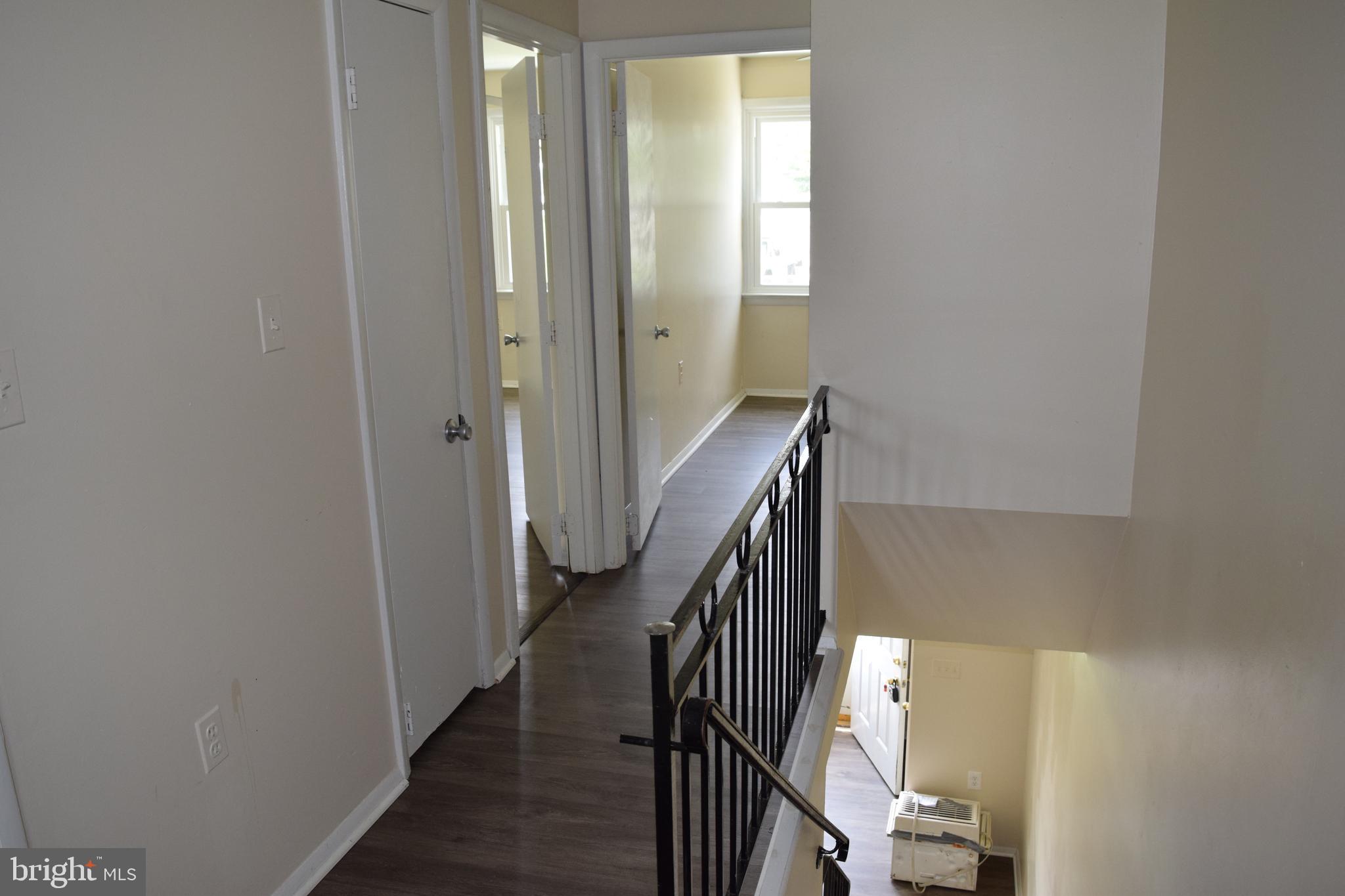 2111 Larkhall Road Baltimore, MD 21222 - Photo 13 of 13 a view of a hallway with wooden floor and entryway