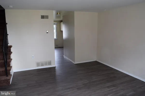 a view of a room with wooden floor