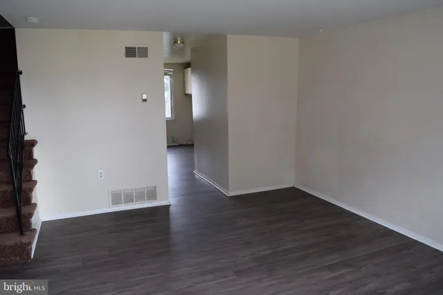 a view of a room with wooden floor