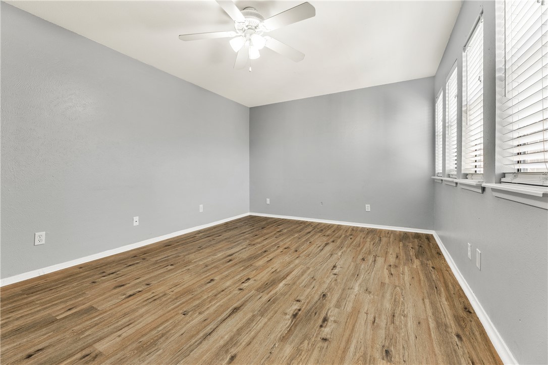 2101 Barak Lane, Unit 17 Bryan, TX 77802 - Photo 3 of 19 an empty room with wooden floor and windows