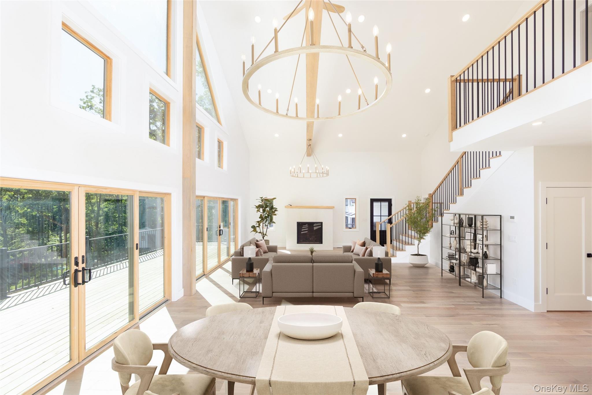 91 Lenni Lenape Road Narrowsburg, NY 12764 - Photo 3 of 25 Vaulted ceiling living space featuring a fireplace, wood-finish flooring, a grand staircase Images have been virtually staged to illustrate the property's potential
