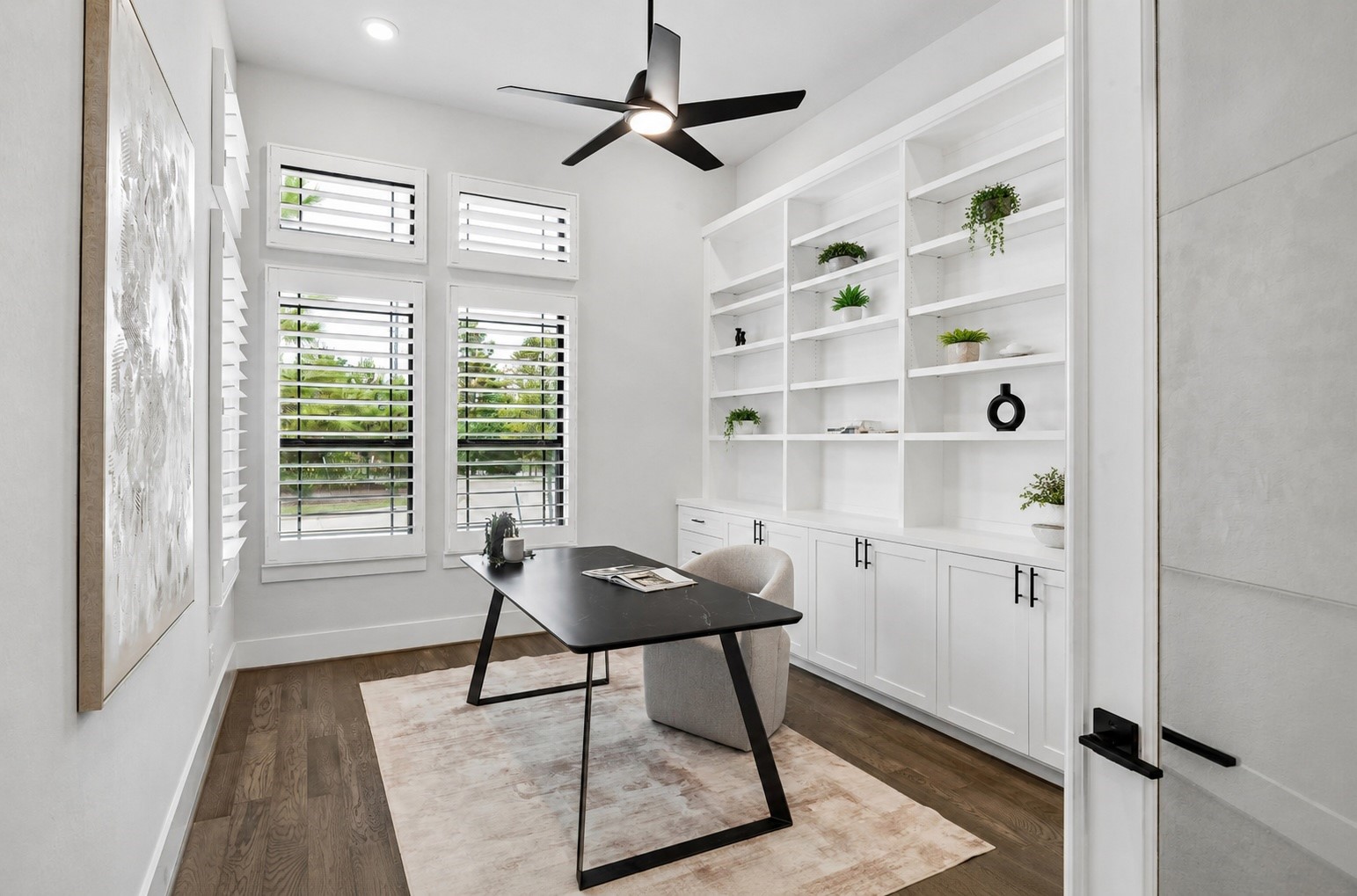 27720 Hazelbrook Lane Spring, TX 77386 - Photo 20 of 48 Your impressive 15'x12' (approximate) Office is lined with beautiful windows letting in a wonderful amount of natural light. Upgraded Plantation Shutters, Modern Ceiling Fan, Recessed Lighting and a wall of Built-In Cabinetry & Shelving have been added to complete this room. There is also a wall mount behind the artwork in the photo for the option to easily mount a TV.