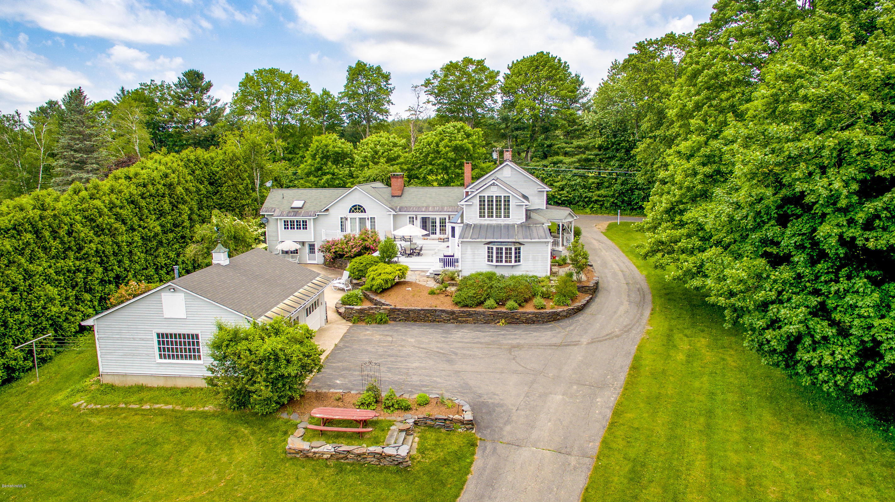 215 Devon Road Lee, MA 01238 - Photo 1 of 59 an aerial view of a house with swimming pool and garden