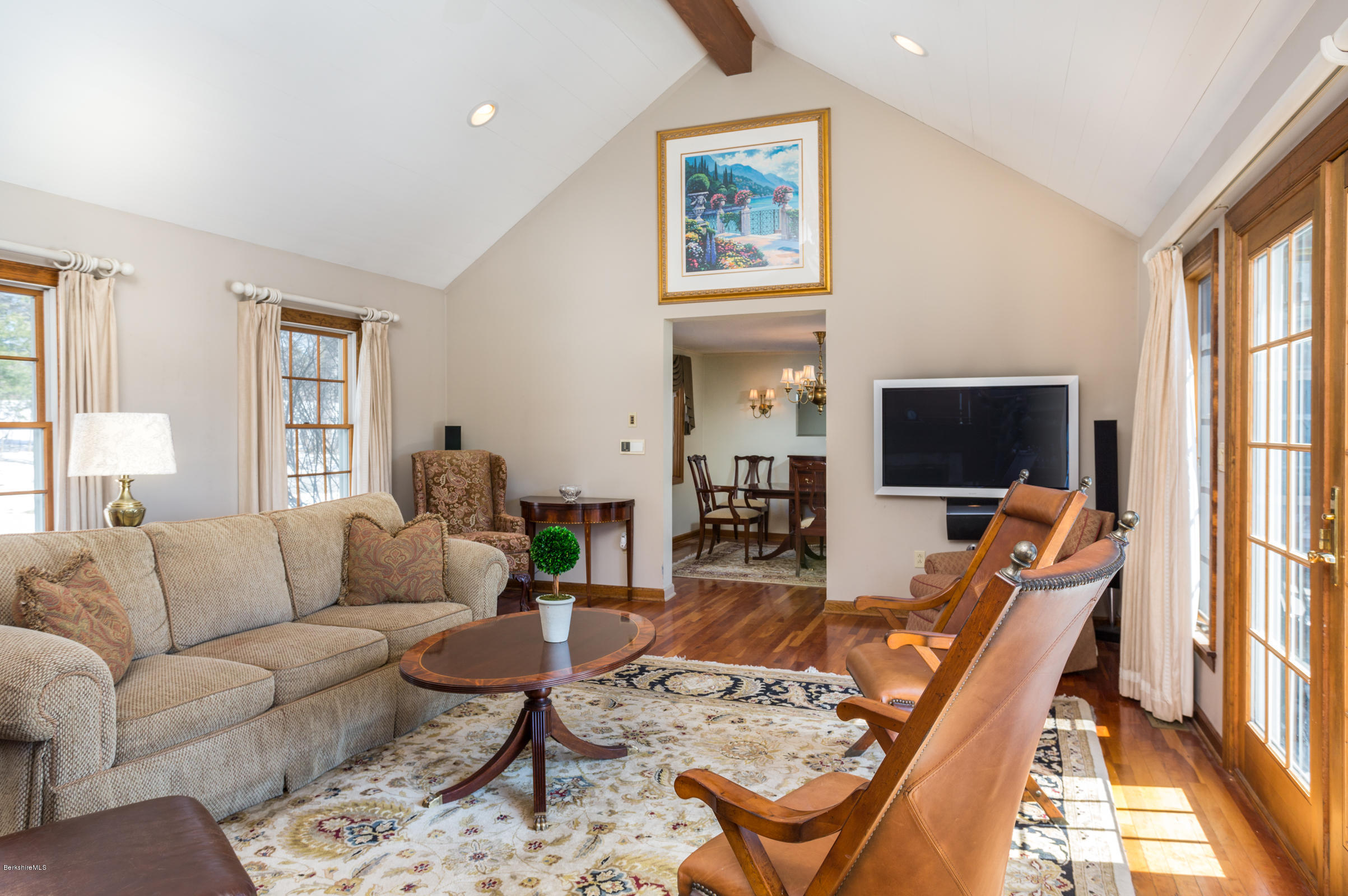215 Devon Road Lee, MA 01238 - Photo 13 of 59 a living room with furniture a flat screen tv and a large window