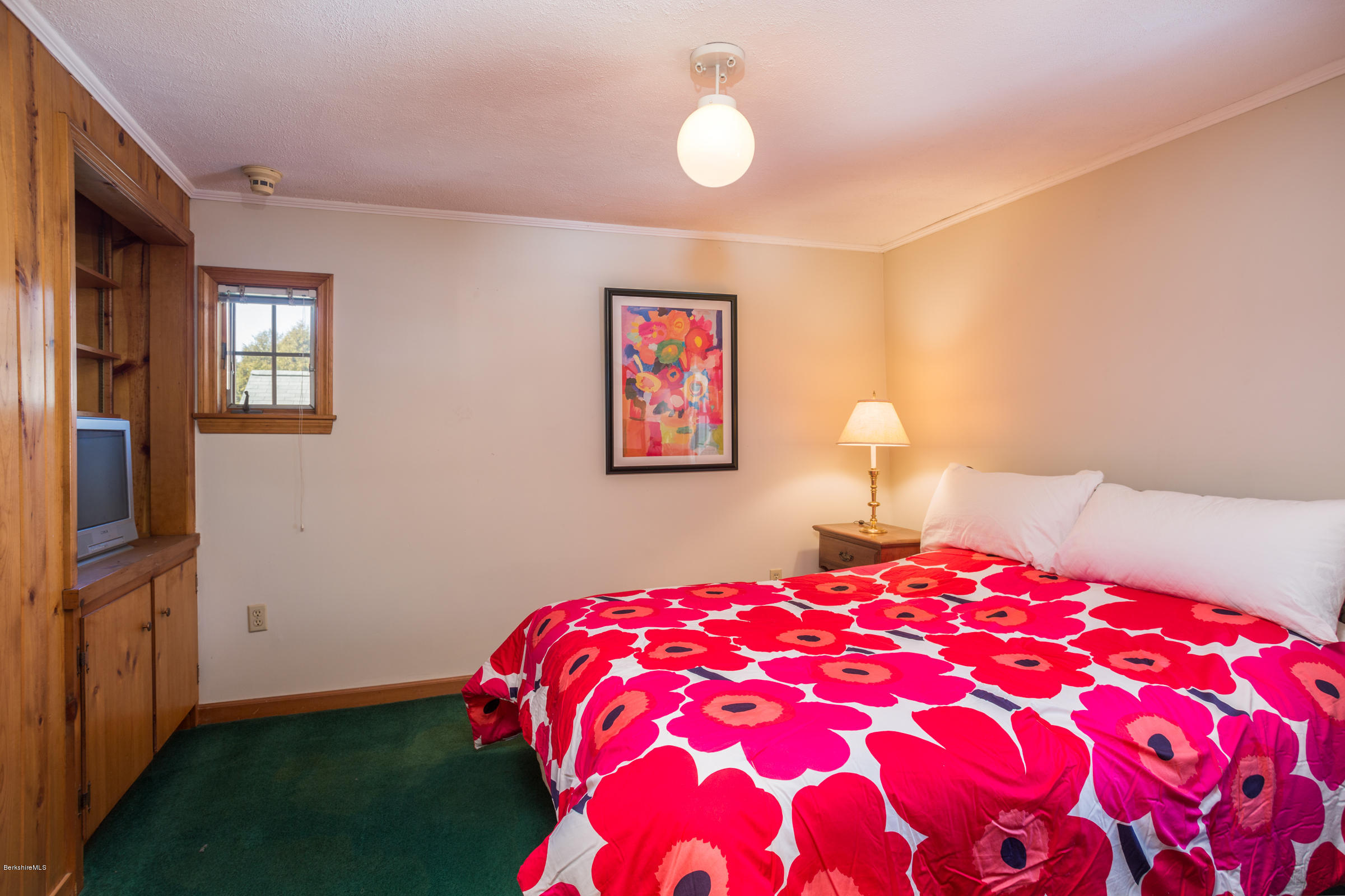 215 Devon Road Lee, MA 01238 - Photo 34 of 59 a bedroom with a bed and a chandelier