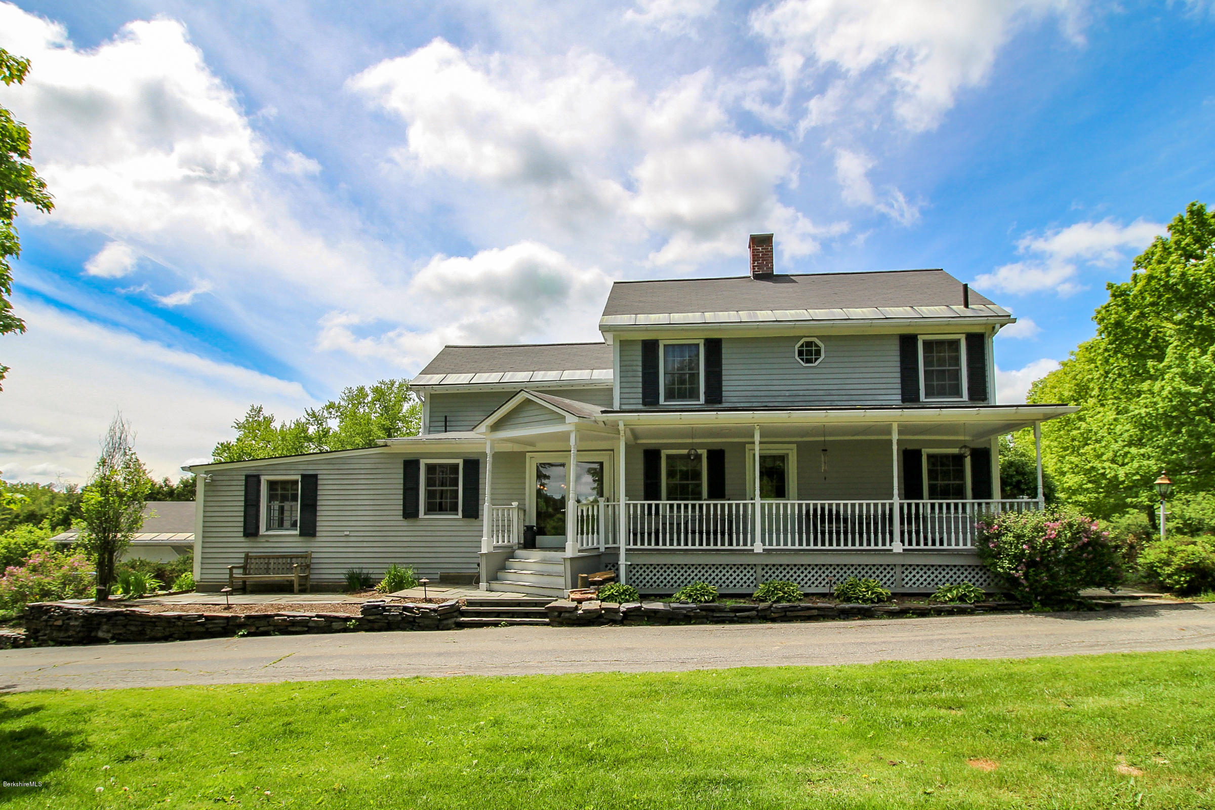 215 Devon Road Lee, MA 01238 - Photo 5 of 59 a front view of a house with a garden