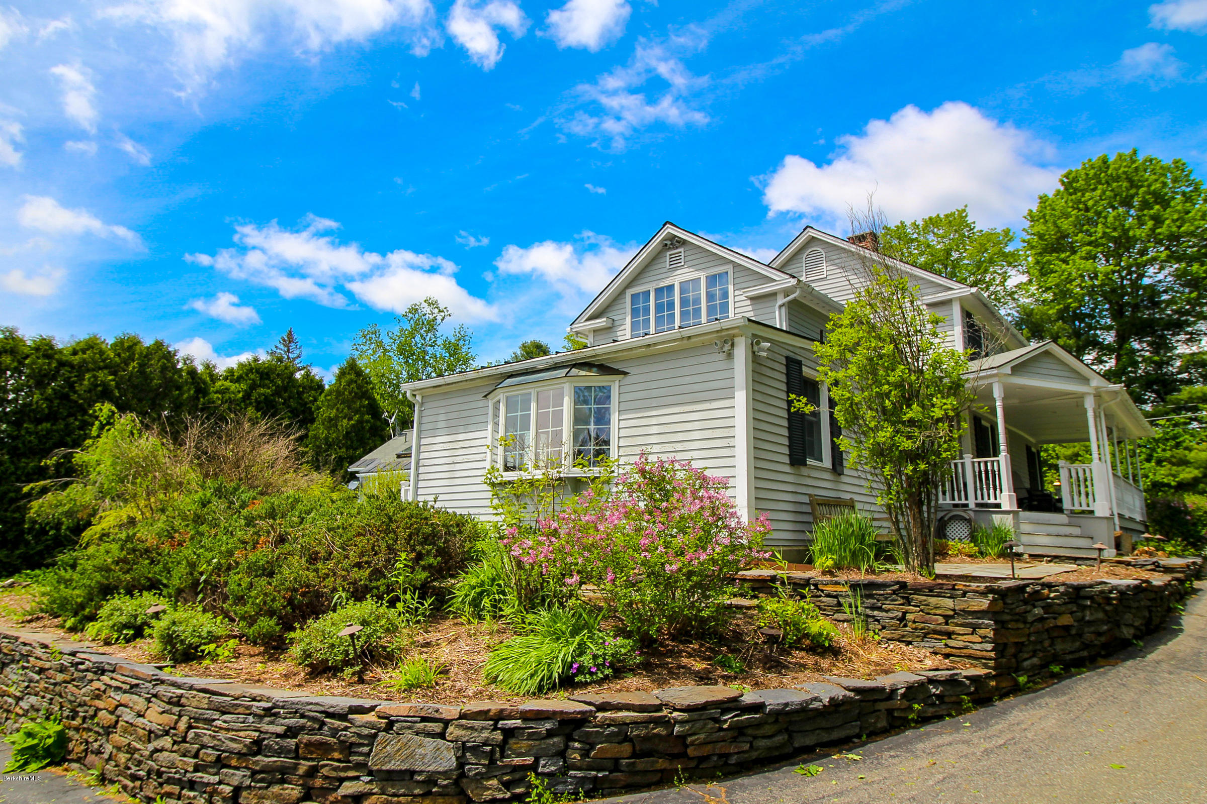 215 Devon Road Lee, MA 01238 - Photo 47 of 59 a front view of a house with a yard