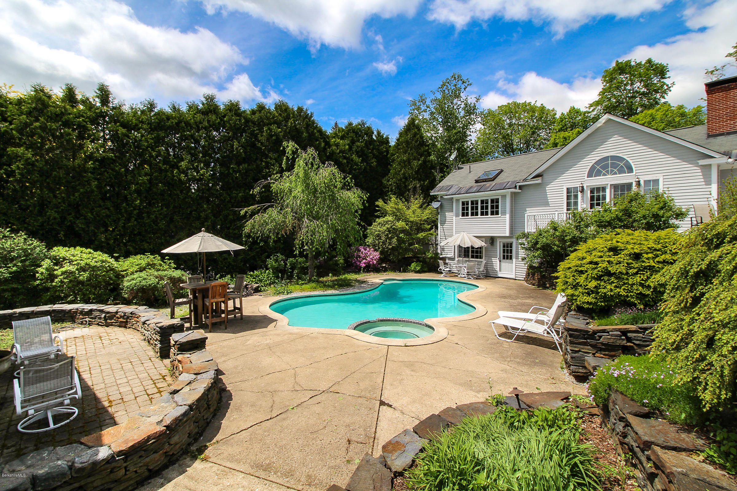 215 Devon Road Lee, MA 01238 - Photo 48 of 59 a view of a house with backyard sitting area and garden