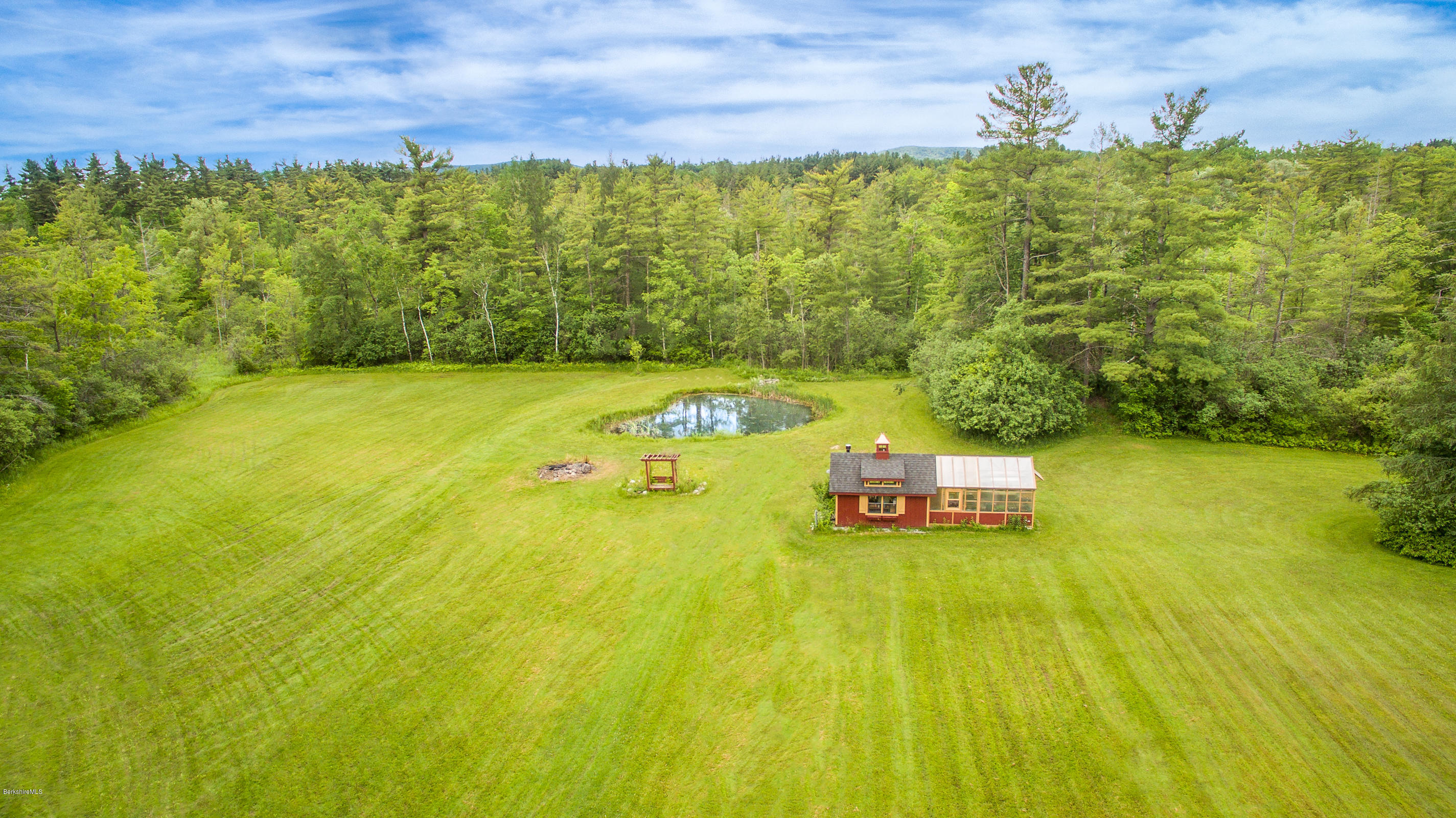 215 Devon Road Lee, MA 01238 - Photo 57 of 59 a view of a swimming pool with an outdoor space and seating area