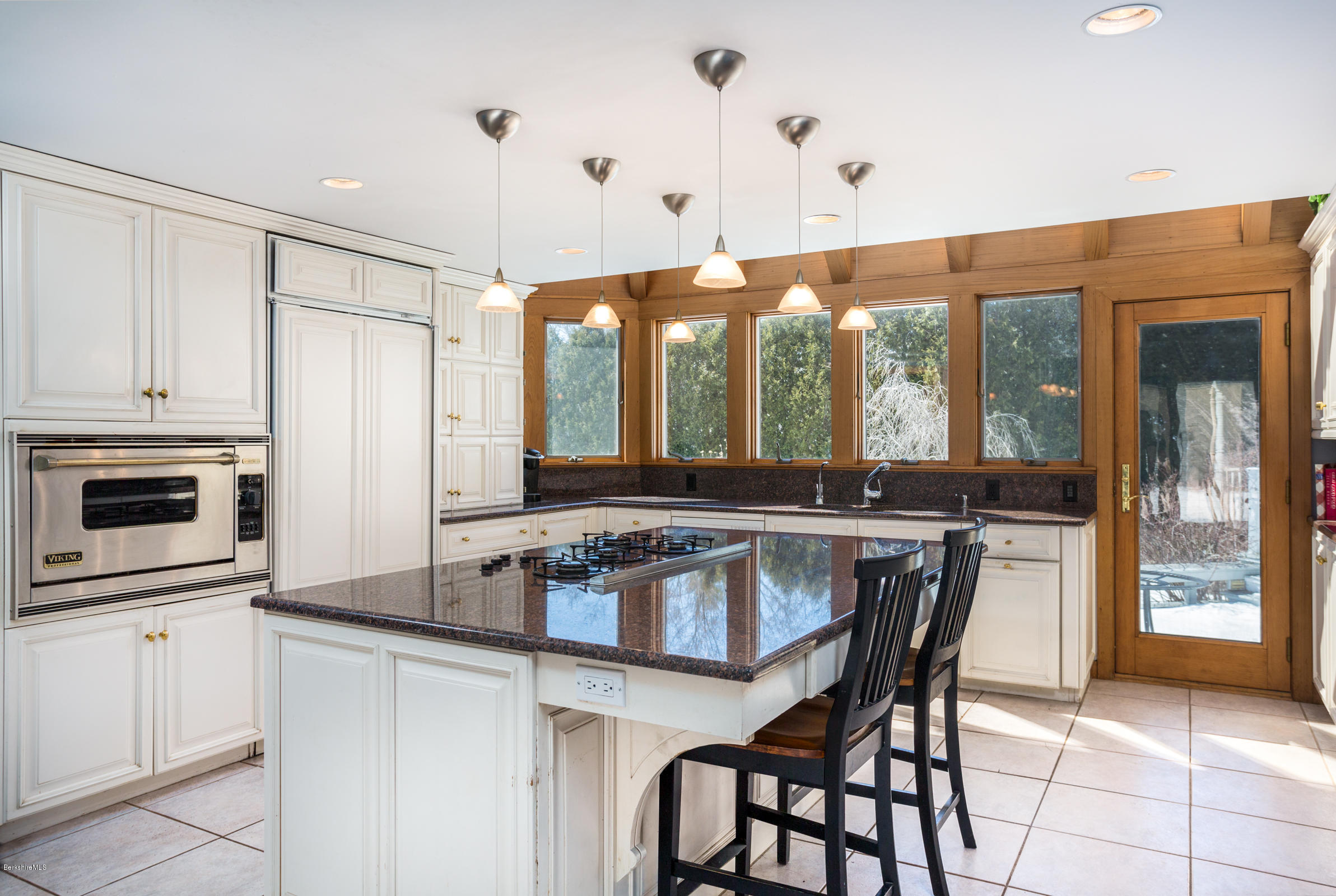 215 Devon Road Lee, MA 01238 - Photo 8 of 59 a kitchen with a table chairs sink and cabinets