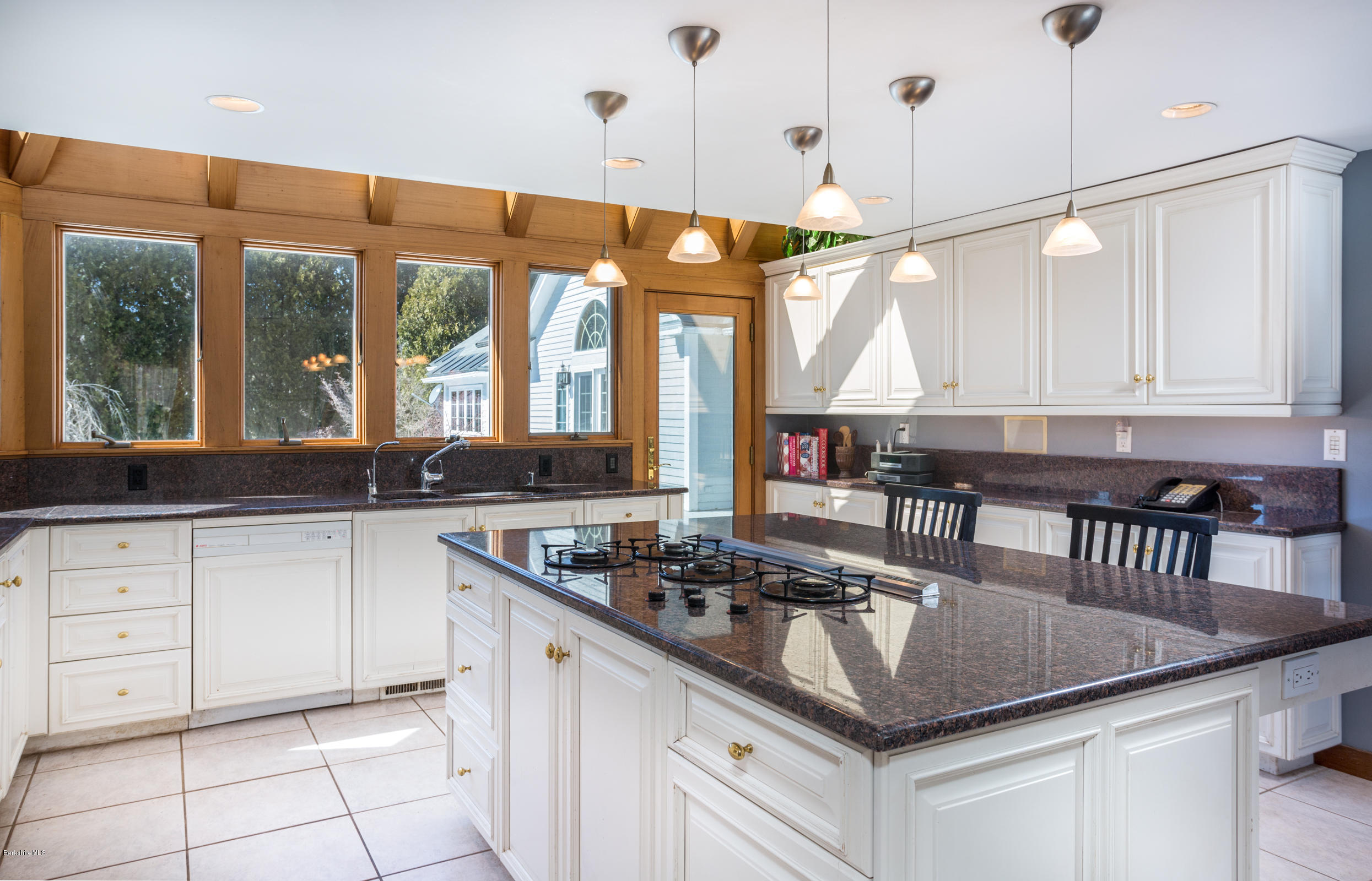 215 Devon Road Lee, MA 01238 - Photo 9 of 59 a kitchen with stainless steel appliances granite countertop a sink a stove and a wooden floor