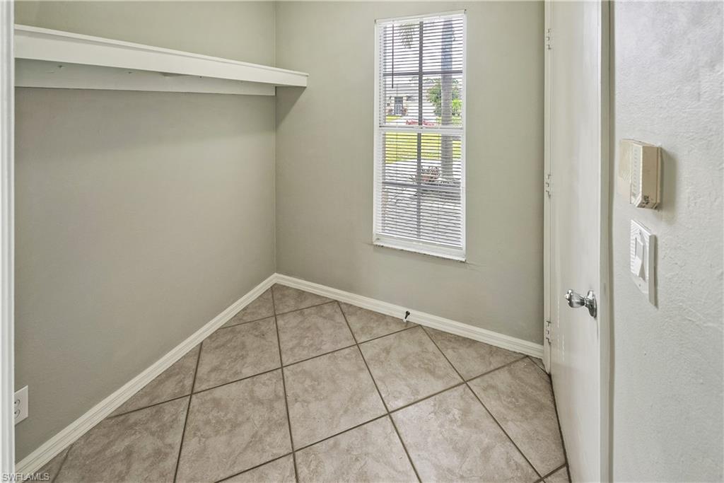 6721 Sloane Place Naples, FL 34104 - Photo 14 of 29 a view of an empty room with a window