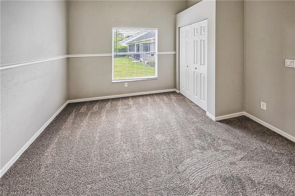 6721 Sloane Place Naples, FL 34104 - Photo 18 of 29 an empty room with windows