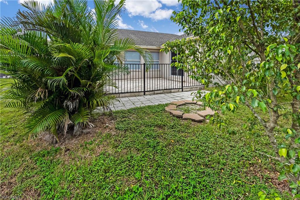 6721 Sloane Place Naples, FL 34104 - Photo 23 of 29 a backyard of a house with lots of green space