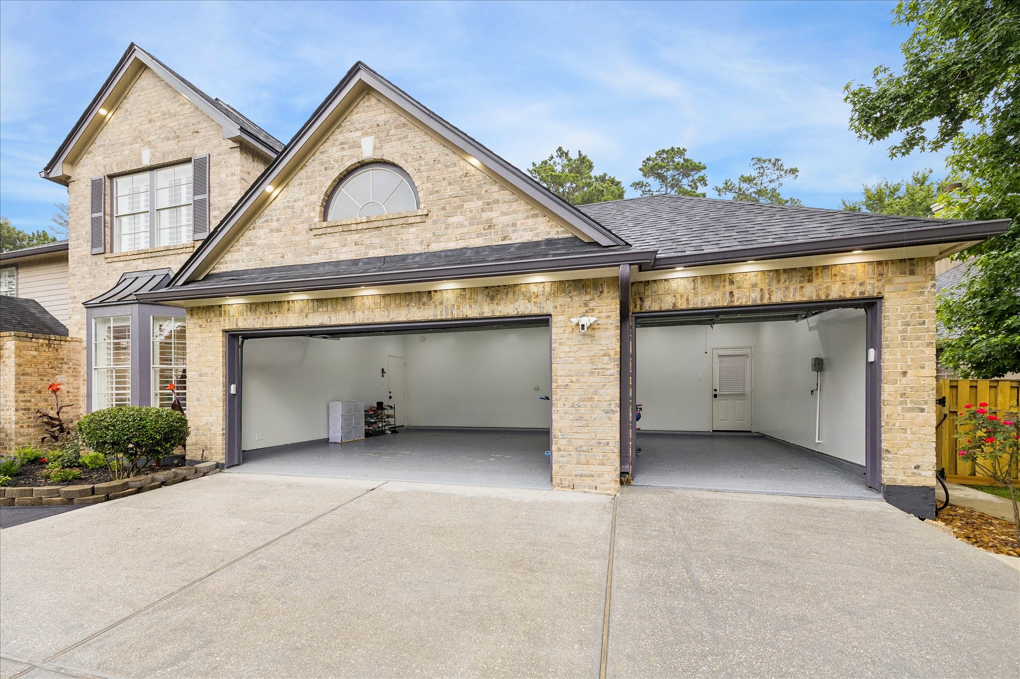 15 West Beckonvale Circle The Woodlands, TX 77382 - Photo 39 of 44 This home features a true three car garage, ideal for multiple vehicles, storage needs, or hobby space. Thoughtfully designed, it includes a rear access door that opens directly to the backyard space.