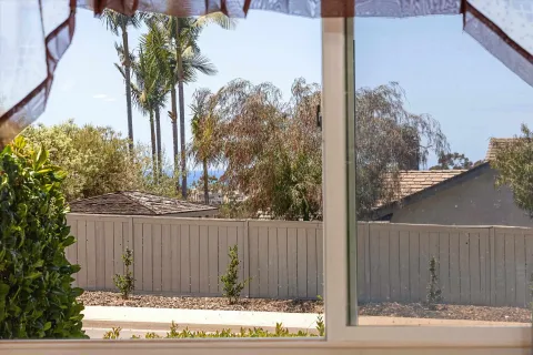 a view of a house with a backyard and trees