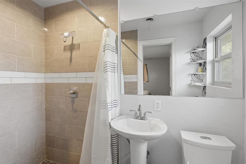 4105 Springbranch Drive Benbrook, TX 76116 - Photo 16 of 27 a bathroom with a sink a toilet and shower