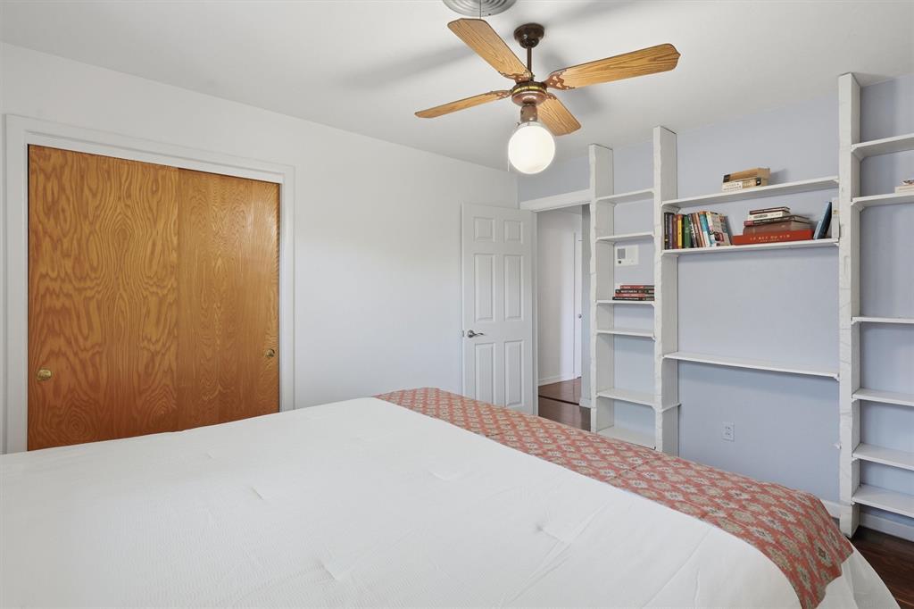 4105 Springbranch Drive Benbrook, TX 76116 - Photo 20 of 27 a bedroom with a bed and a chandelier