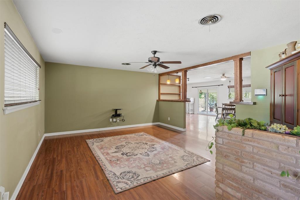 4105 Springbranch Drive Benbrook, TX 76116 - Photo 5 of 27 a view of a hallway with wooden floor and a living room