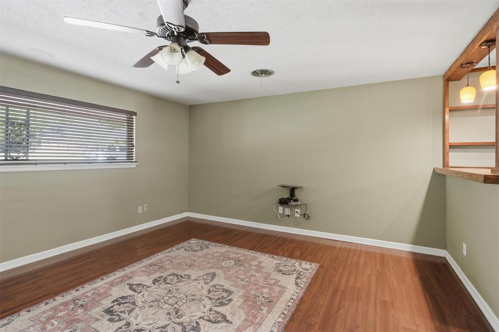 4105 Springbranch Drive Benbrook, TX 76116 - Photo 7 of 27 a view of a room with a wooden floor and white walls