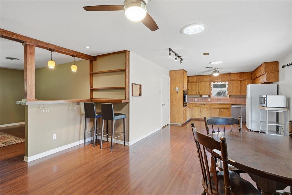 4105 Springbranch Drive Benbrook, TX 76116 - Photo 9 of 27 a view of a dining room with furniture and wooden floor