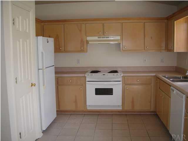 2797 Augustus Road Navarre, FL 32566 - Photo 4 of 7 Large kitchen with nice cabinetry and tiled floors